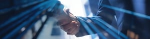Businessmen making handshake with partner