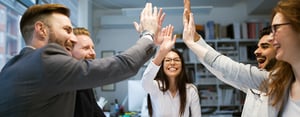 group of people high fiving at meeting_1280x500